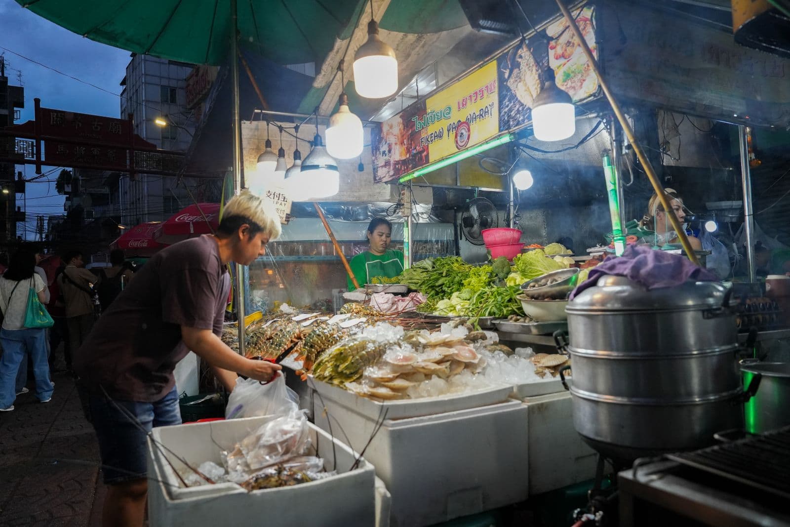 A seafood stall and its prep counter in a Yaowarat alley