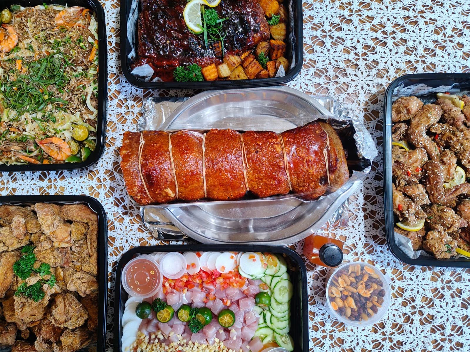 A table spread with Filipino dishes, lechon among them