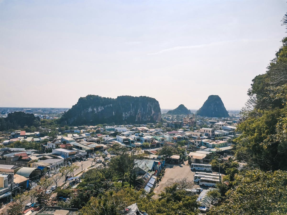 View from the Marble Mountains (Ngu Hanh Son) over Da Nang, five marble peaks rise above the coastal city with the sea in the distance.