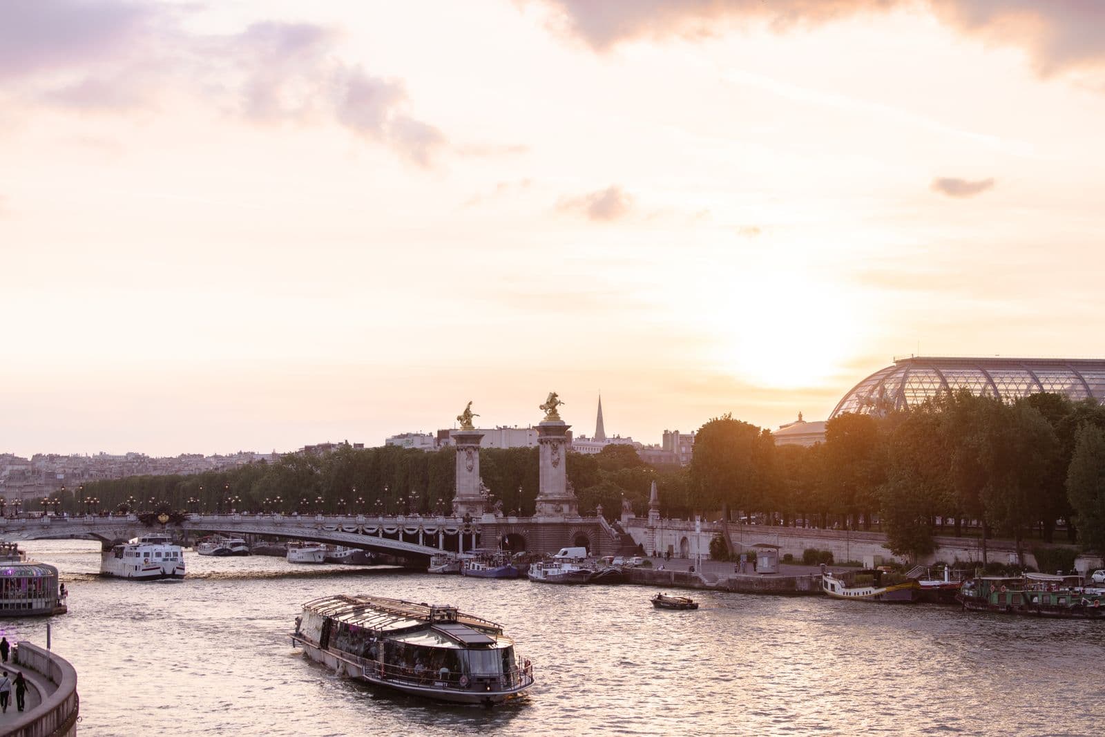 The Seine at dusk with Pont Alexandre III and a cruise boat