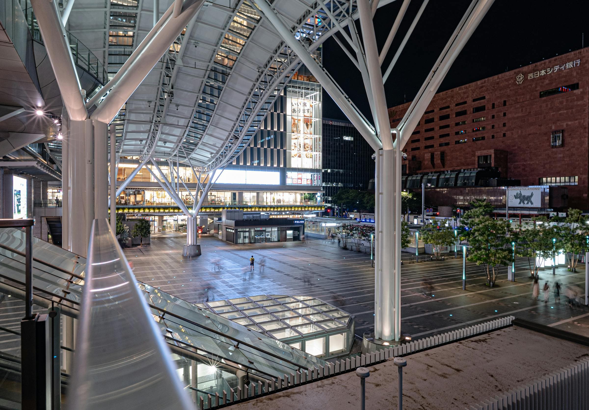 Hakata Station exterior and plaza lit up at night