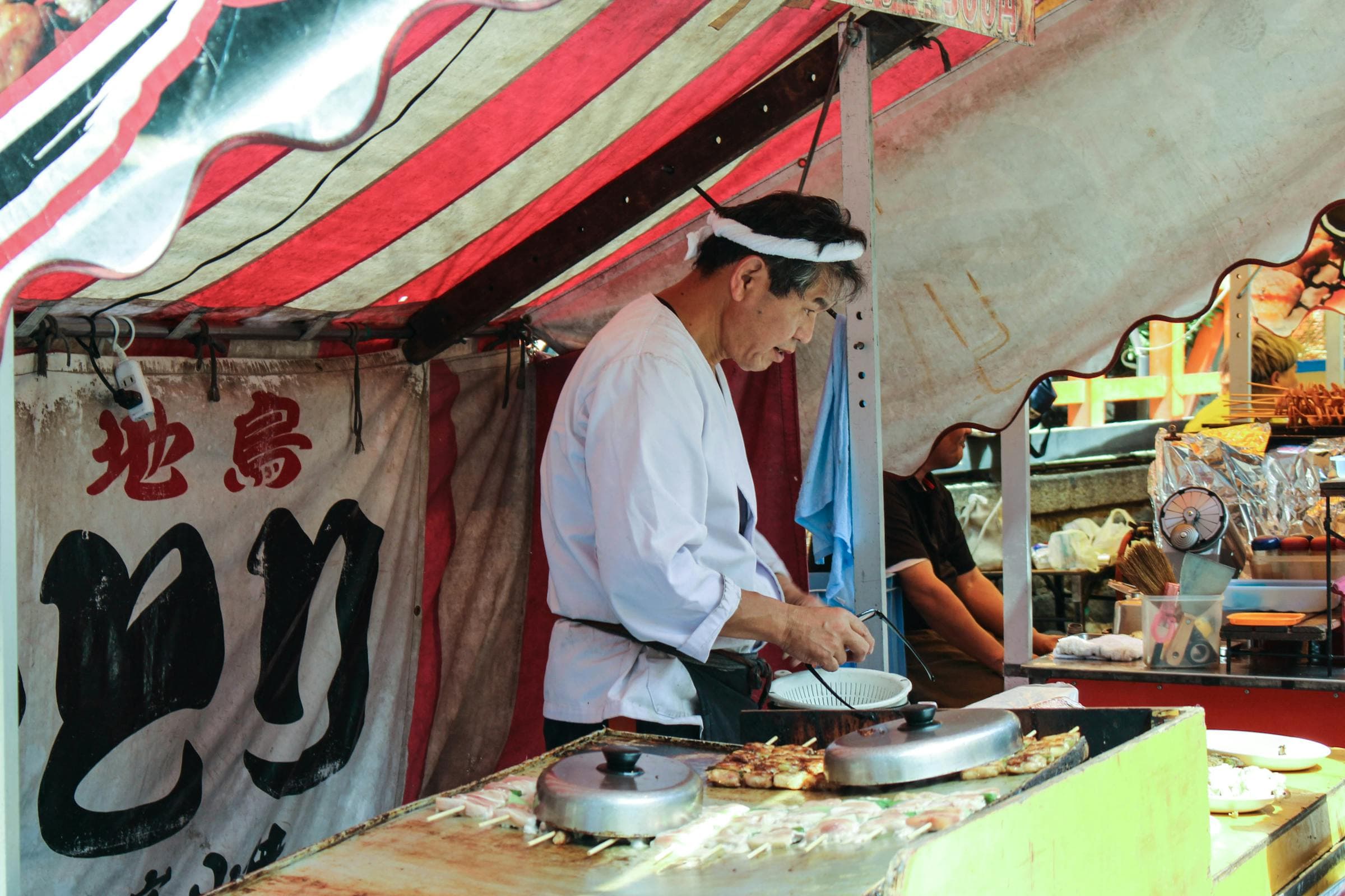 Food stalls lined up along the Nakasu riverside at night
