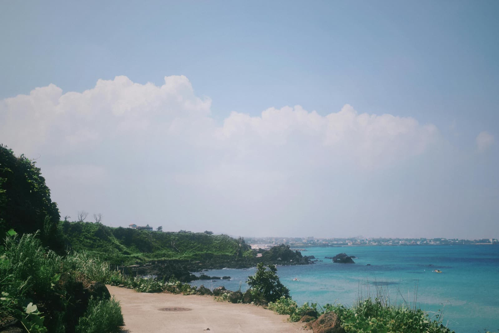 Jeju's west coast near Hyeopjae, emerald sea and rocky coastline with Biyangdo island view