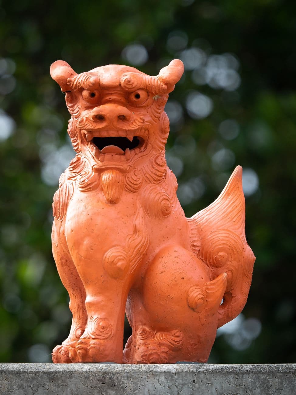 Front view of an Okinawan shisa figure in red-brown pottery