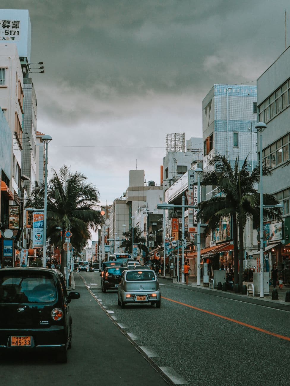 Kokusai Street in Naha lined with palm trees and shop signs