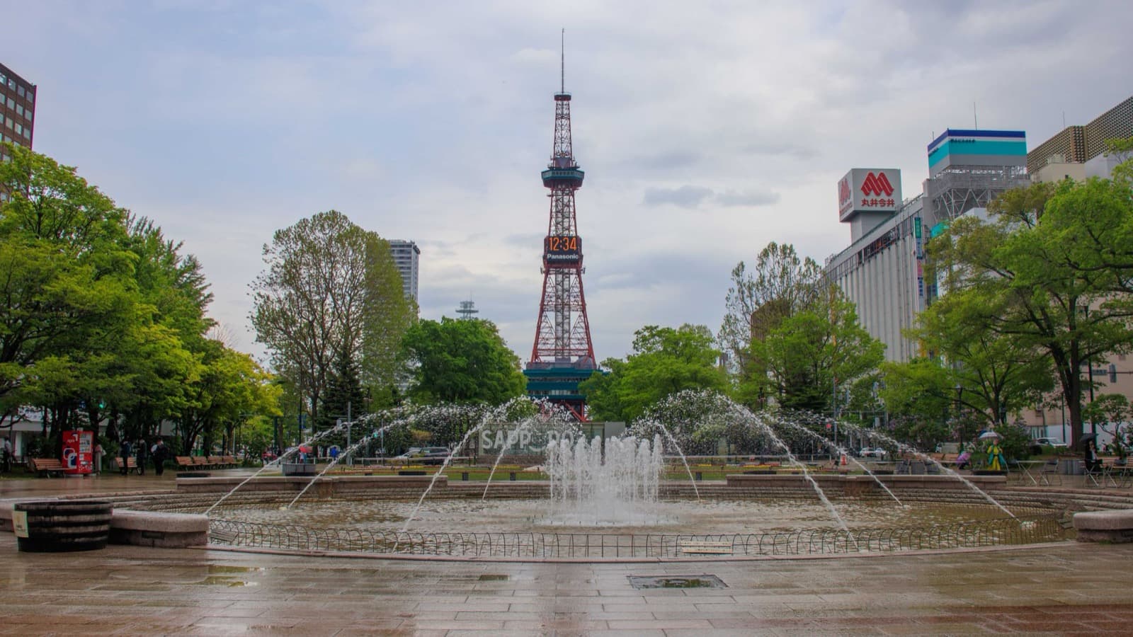 Sapporo TV Tower seen over the Odori Park fountain in summer green, shown for location reference