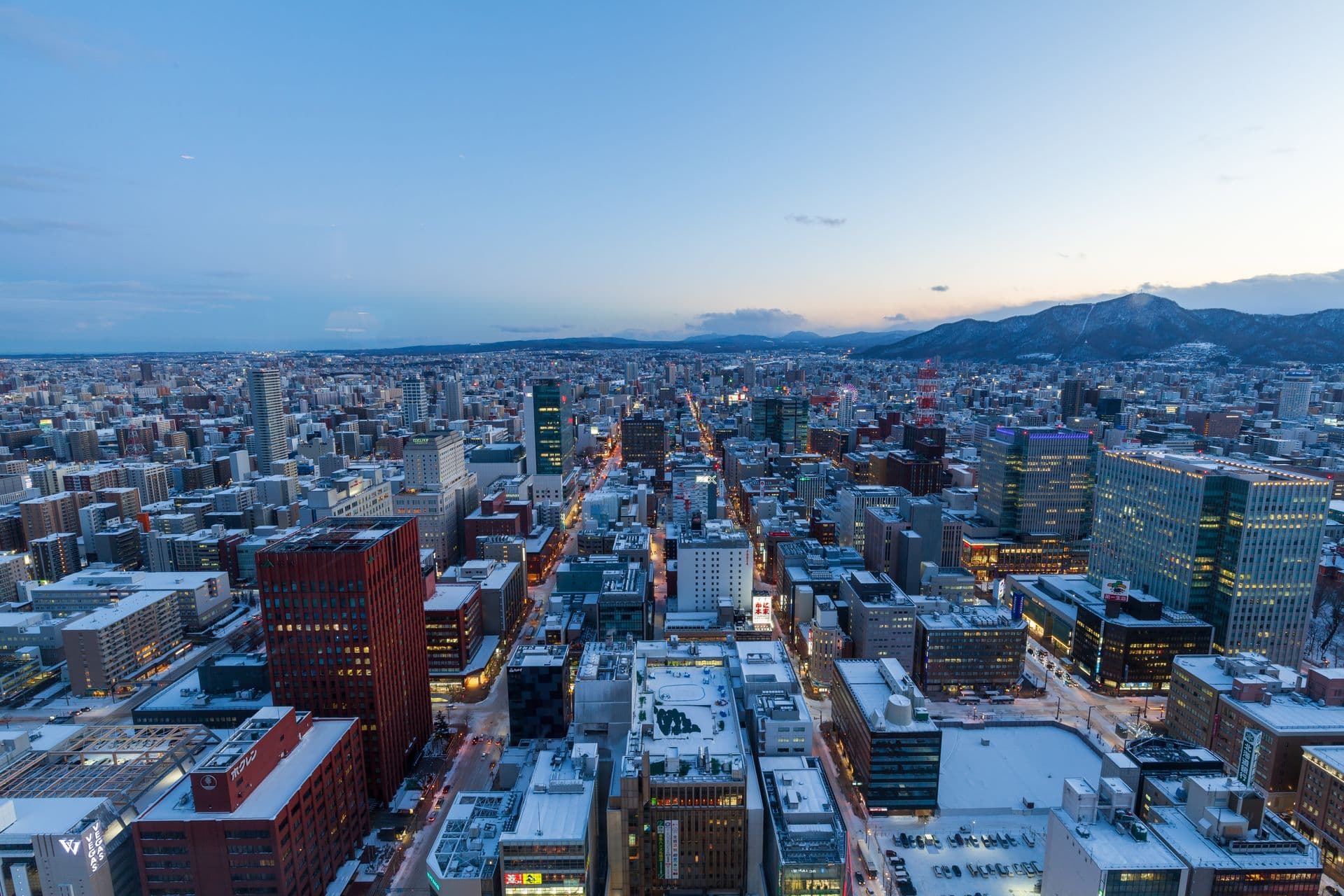 Snow-covered downtown Sapporo seen from above at dusk