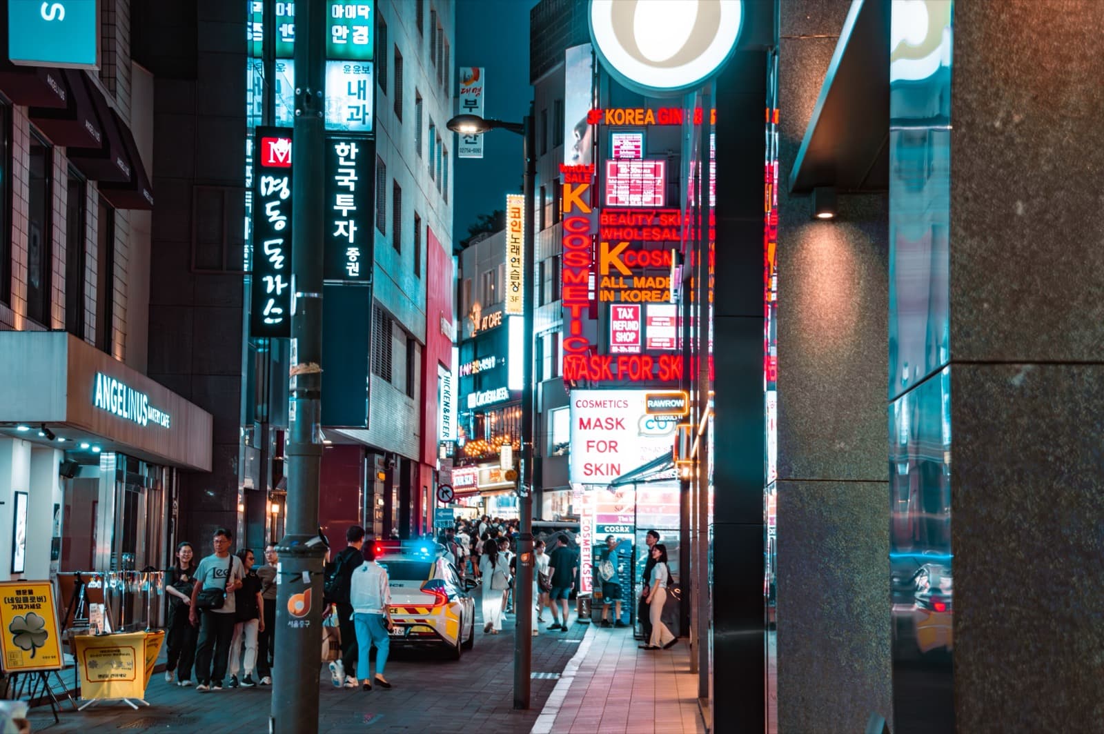 Myeongdong at night, neon signs glowing over the shopping streets